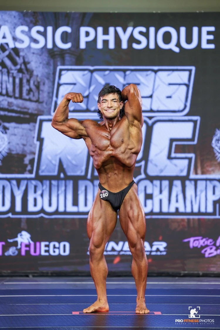 Zack Granly front double biceps in Classic Physique at the 2026 NPC USA Championships