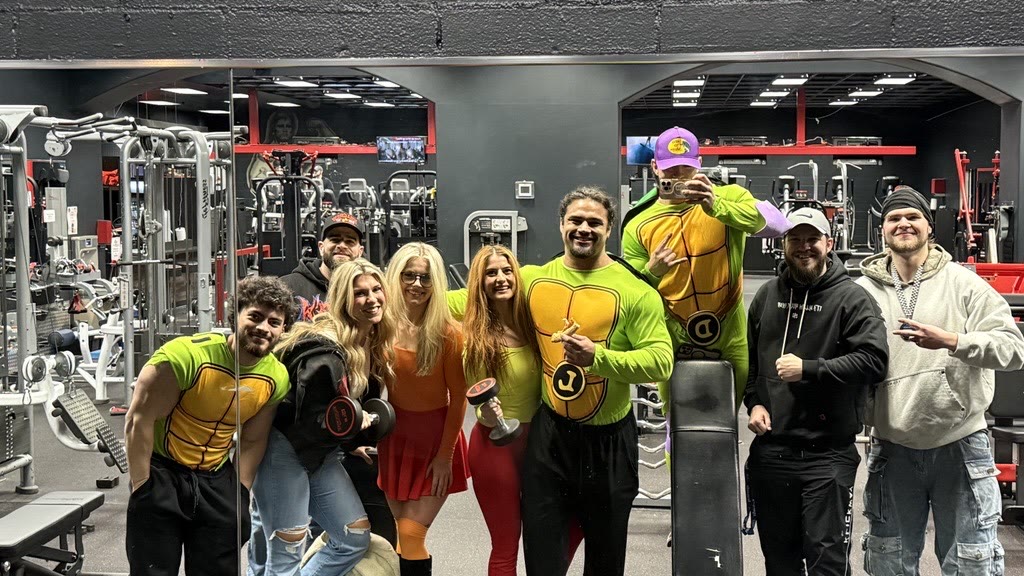 KlickWay team members in Halloween costumes on the gym floor