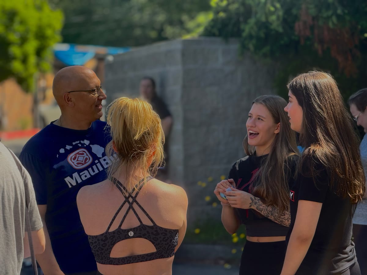 KlickWay members laughing together at an outdoor community event