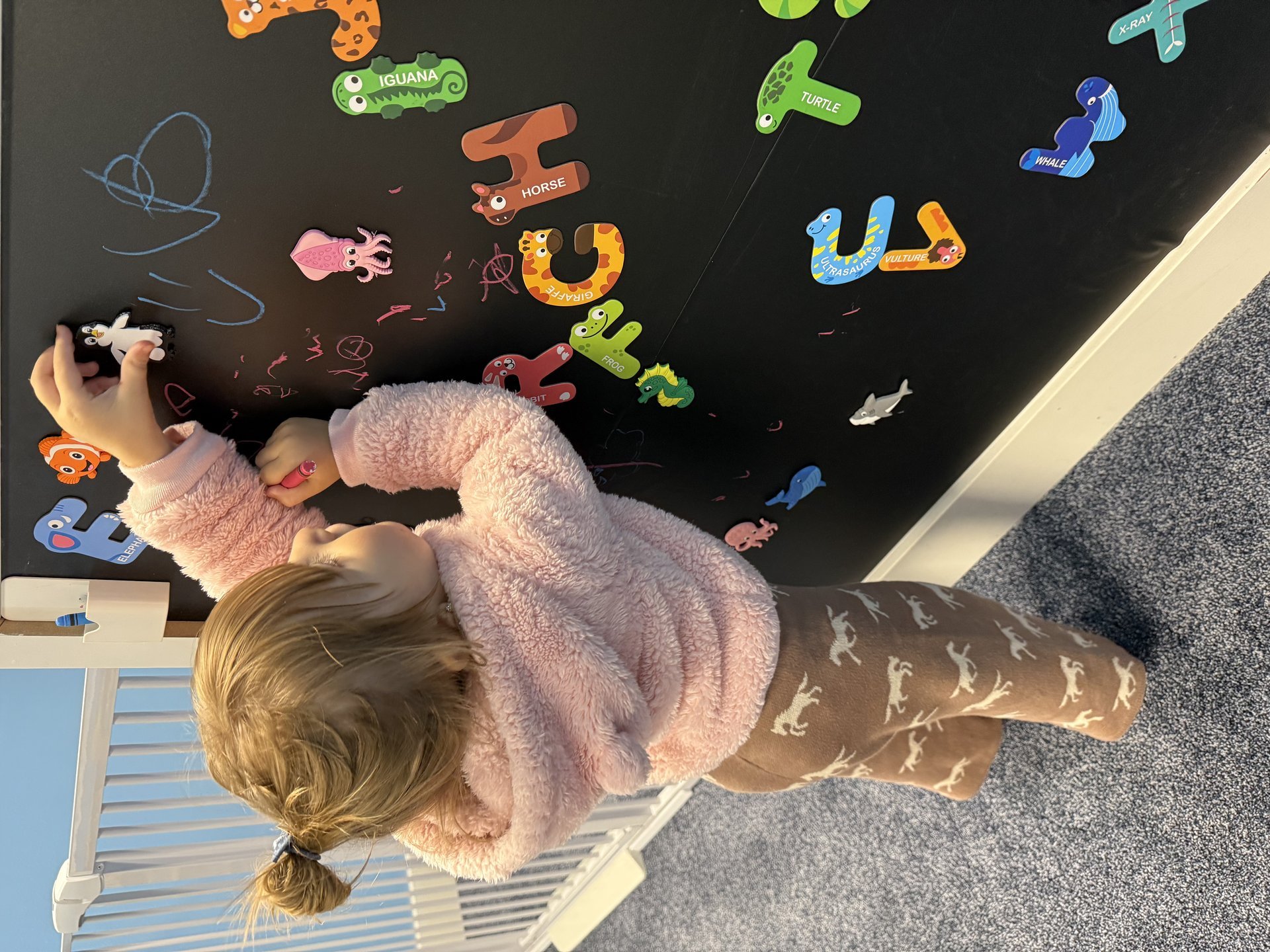 Child playing on activity board