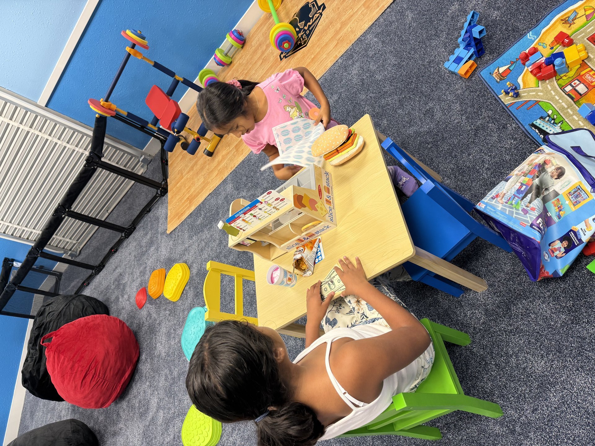Two kids playing together at table
