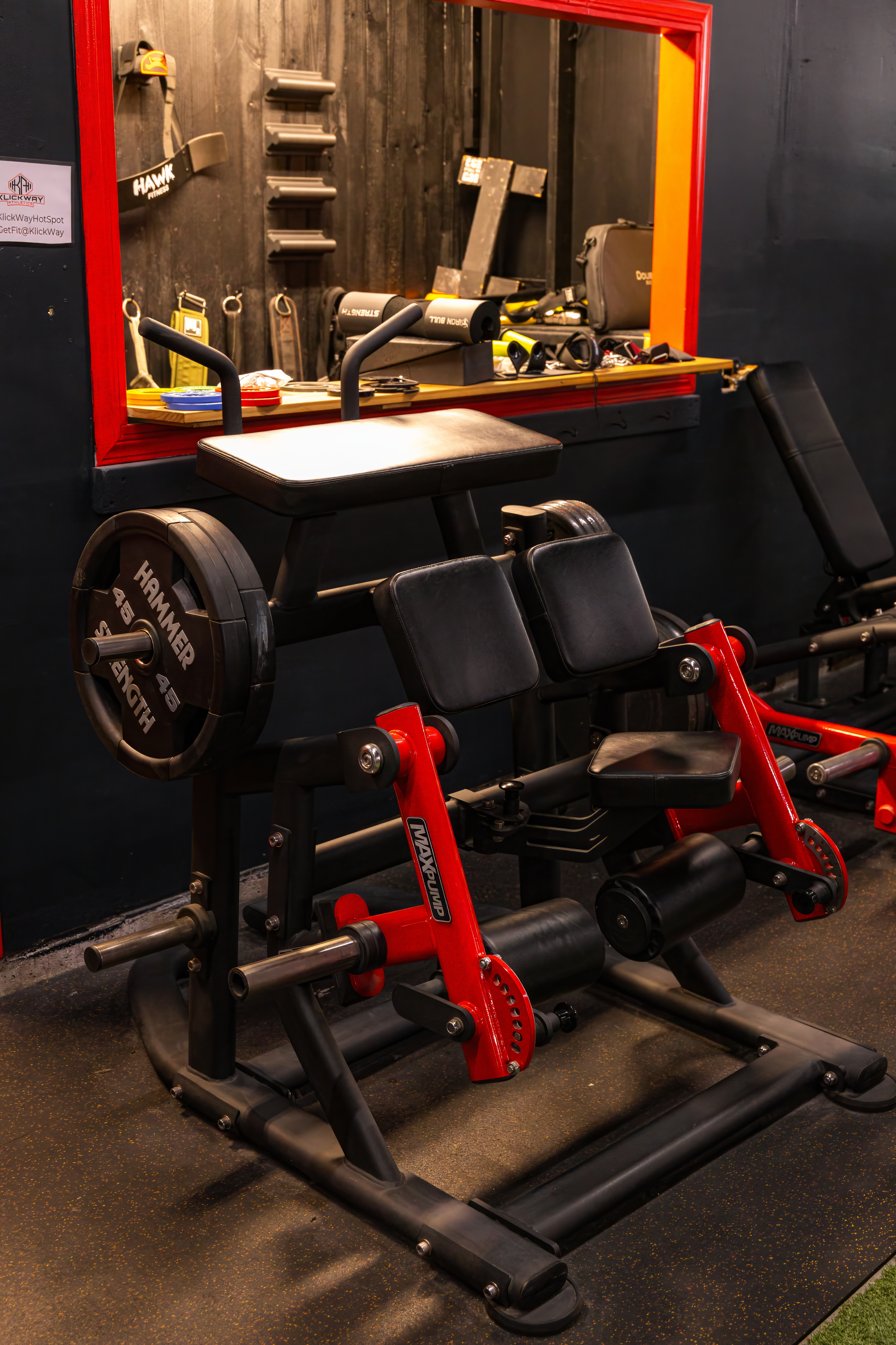 Close-up of a plate-loaded glute-ham raise machine by Hammer Strength, an essential piece of equipment for building powerful glutes and hamstrings