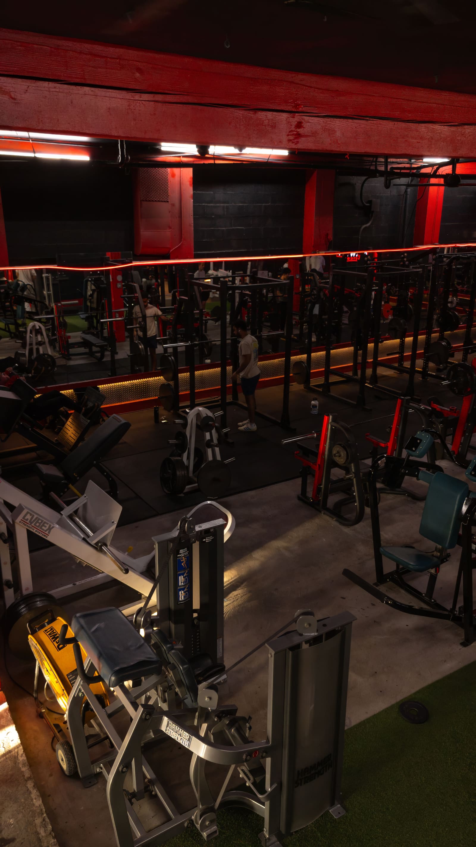 Full array of heavy lifting and strength training machines in the gym, including leg presses and Hammer Strength equipment